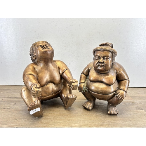 669 - Two resin sumo wrestlers figurines - approx. 31cm high