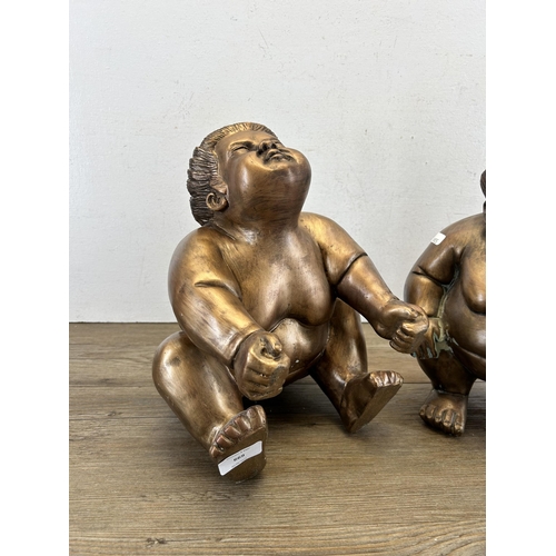 669 - Two resin sumo wrestlers figurines - approx. 31cm high