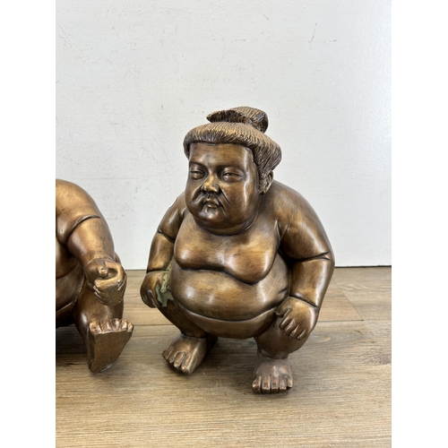 669 - Two resin sumo wrestlers figurines - approx. 31cm high