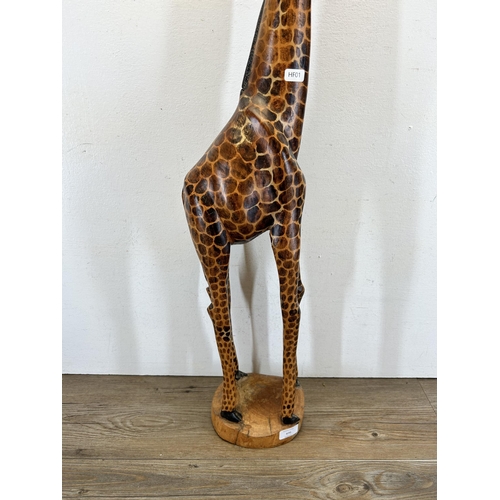 670 - A carved hardwood giraffe figurine - approx. 91cm high