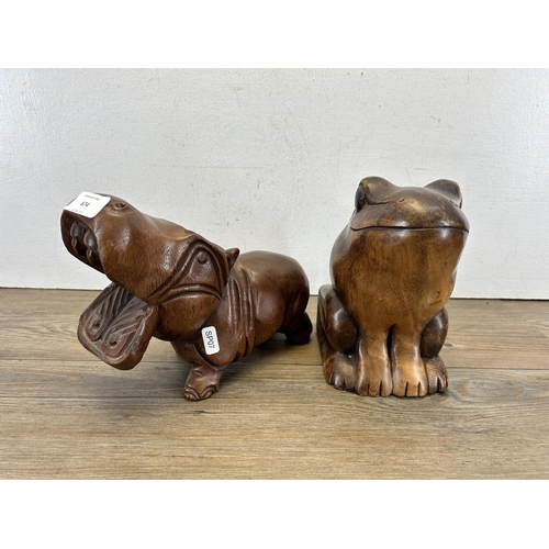 674 - Two carved hardwood animal figurines - largest approx. 20cm high