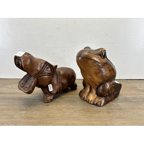 674 - Two carved hardwood animal figurines - largest approx. 20cm high