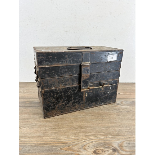 678 - An early/mid 20th century black metal cantilever three section medical box with contents