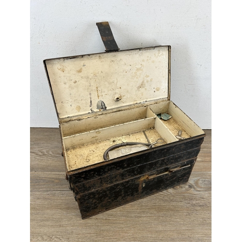 678 - An early/mid 20th century black metal cantilever three section medical box with contents