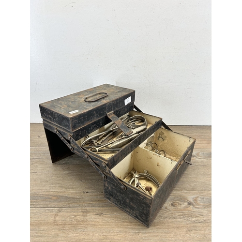 678 - An early/mid 20th century black metal cantilever three section medical box with contents