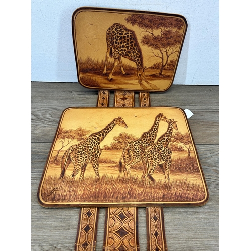 679 - A hand tooled leather tryptic giraffe wall hanging, signed G. Jacobs 2000 - approx. 80cm high