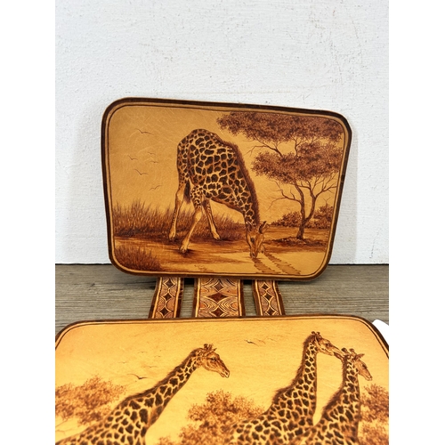 679 - A hand tooled leather tryptic giraffe wall hanging, signed G. Jacobs 2000 - approx. 80cm high