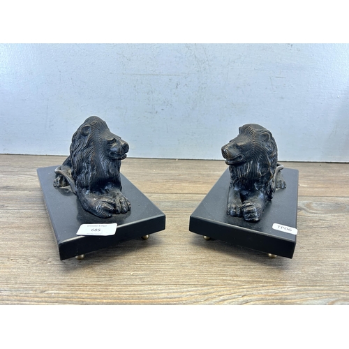 685 - A pair of bronze lion figurines on black marble plinths - approx. 14cm high x 23.5cm wide x 11cm dee... 