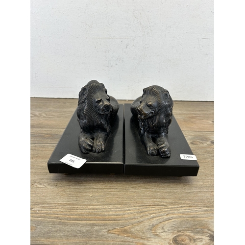 685 - A pair of bronze lion figurines on black marble plinths - approx. 14cm high x 23.5cm wide x 11cm dee... 