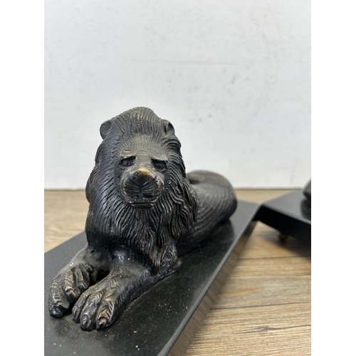 685 - A pair of bronze lion figurines on black marble plinths - approx. 14cm high x 23.5cm wide x 11cm dee... 