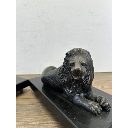 685 - A pair of bronze lion figurines on black marble plinths - approx. 14cm high x 23.5cm wide x 11cm dee... 