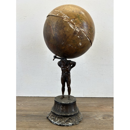 686A - An early 20th century spelter figurine of Atlas holding up Geographia 8