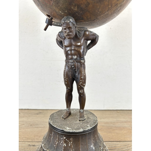 686A - An early 20th century spelter figurine of Atlas holding up Geographia 8