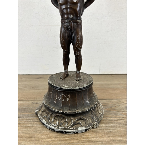 686A - An early 20th century spelter figurine of Atlas holding up Geographia 8