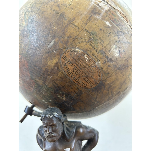 686A - An early 20th century spelter figurine of Atlas holding up Geographia 8