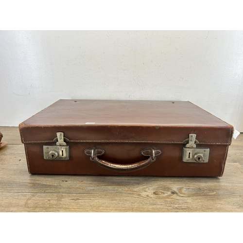 698 - A vintage brown leather suitcase with contents