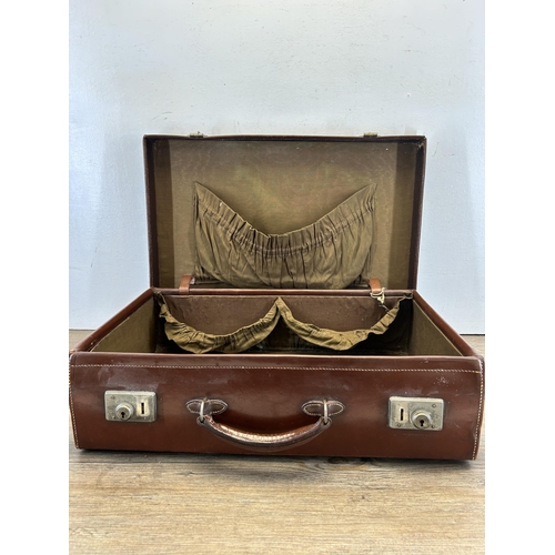 698 - A vintage brown leather suitcase with contents