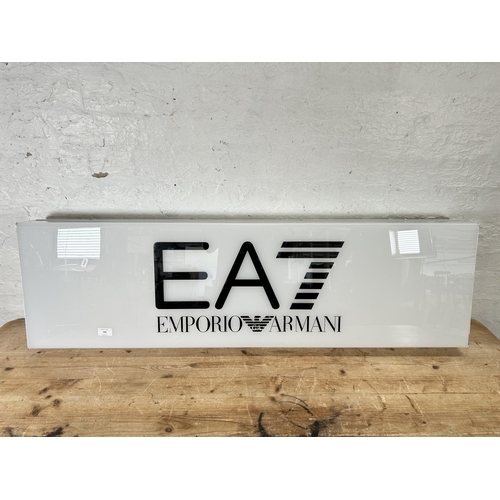 700 - An Emporio Armani illuminating advertising sign - approx. 35cm high x 122cm wide