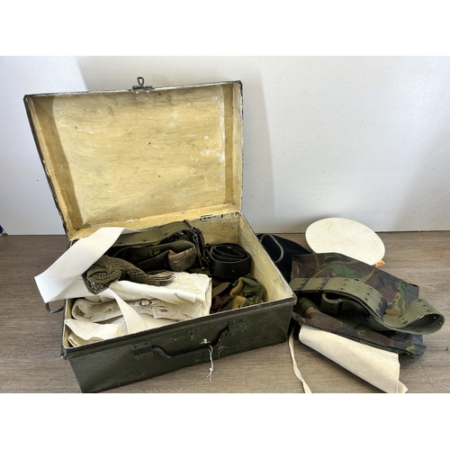 702 - A military green metal travel trunk containing military clothing and accessories to include 1951 Lut... 