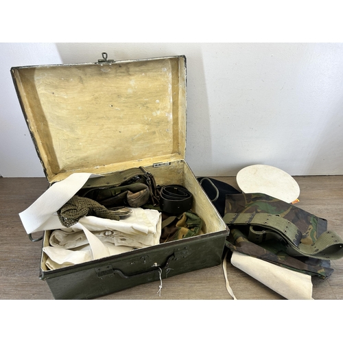 702 - A military green metal travel trunk containing military clothing and accessories to include 1951 Lut... 