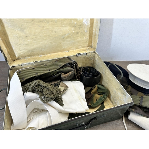 702 - A military green metal travel trunk containing military clothing and accessories to include 1951 Lut... 