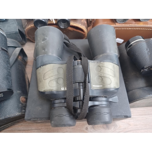 802 - Seven pairs of binoculars to include Chinon, Greenkat 8 x 30, Palar 16 x 50, Pathéscope 10 x 50, Mir... 