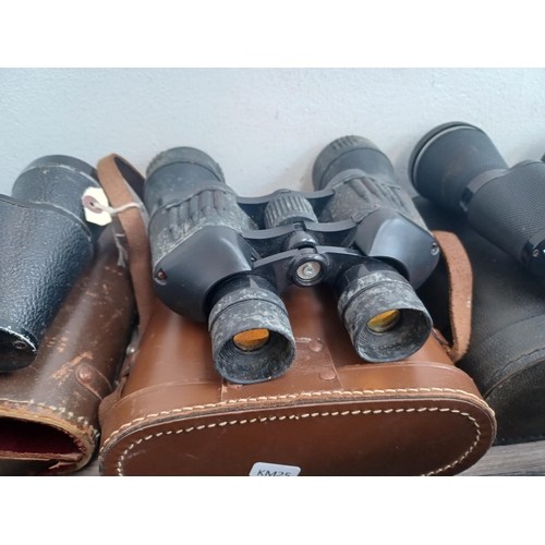 802 - Seven pairs of binoculars to include Chinon, Greenkat 8 x 30, Palar 16 x 50, Pathéscope 10 x 50, Mir... 