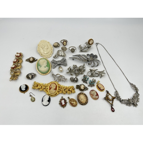 1201 - A collection of vintage costume jewellery to include cameo dress rings, cameo brooches etc.