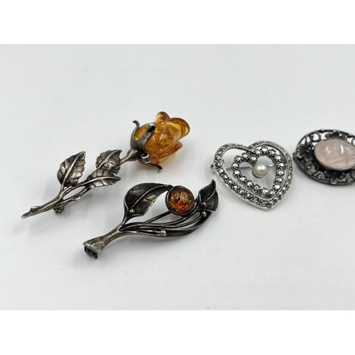 1204 - Five silver brooches to include amber rose, amber leaf etc.