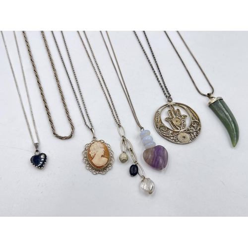 1206 - A collection of .925 silver pendant necklaces to include cameo, nephrite claw etc.