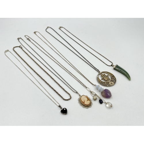 1206 - A collection of .925 silver pendant necklaces to include cameo, nephrite claw etc.