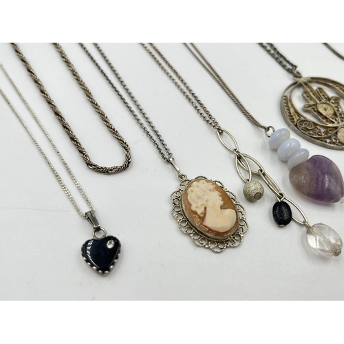 1206 - A collection of .925 silver pendant necklaces to include cameo, nephrite claw etc.