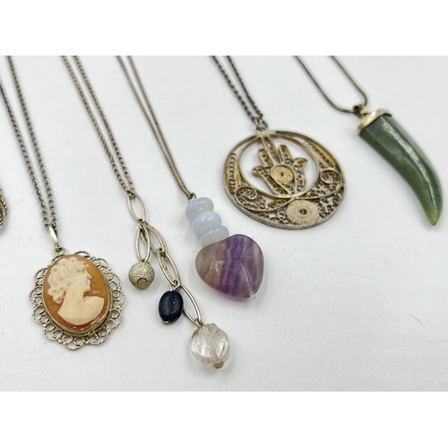 1206 - A collection of .925 silver pendant necklaces to include cameo, nephrite claw etc.