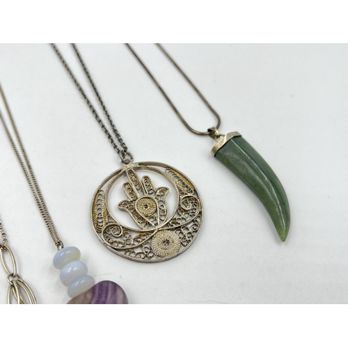 1206 - A collection of .925 silver pendant necklaces to include cameo, nephrite claw etc.