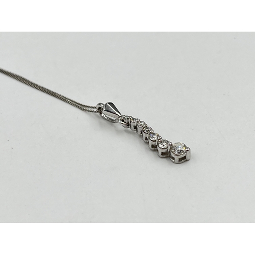 1214 - A hallmarked 18ct white gold diamond static pendant on 9ct white gold chain necklace - approx. gross... 