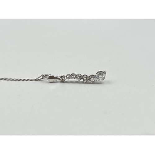 1214 - A hallmarked 18ct white gold diamond static pendant on 9ct white gold chain necklace - approx. gross... 