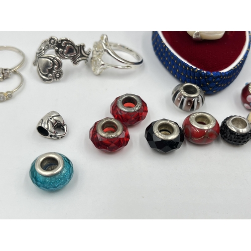 1215 - A collection of .925 silver rings and charms