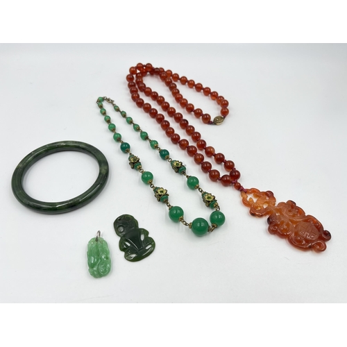 1220 - Five pieces of Oriental gemstone jewellery to include carnelian amulet pendant necklace with silver ... 