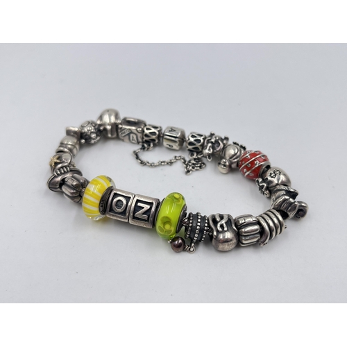 1233D - A Pandora .925 silver charm bracelet with assorted charms - approx. gross weight 82 grams