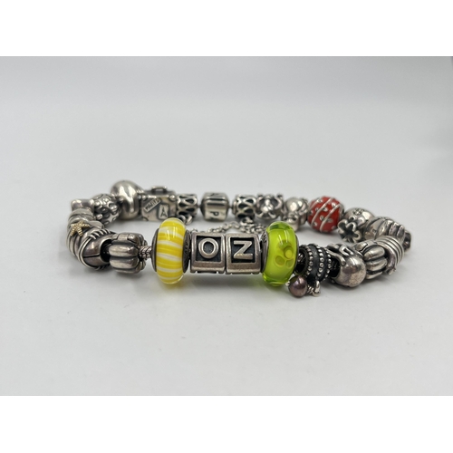 1233D - A Pandora .925 silver charm bracelet with assorted charms - approx. gross weight 82 grams