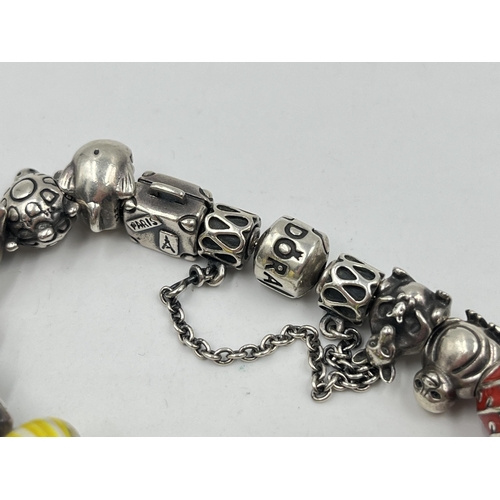 1233D - A Pandora .925 silver charm bracelet with assorted charms - approx. gross weight 82 grams