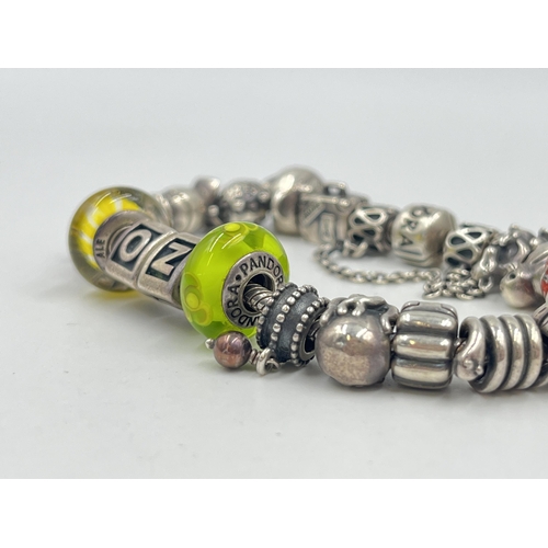 1233D - A Pandora .925 silver charm bracelet with assorted charms - approx. gross weight 82 grams