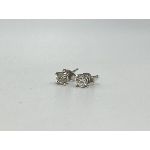 1233E - A pair of hallmarked 18ct white gold diamond stud earrings - approx. gross weight 1.12 grams