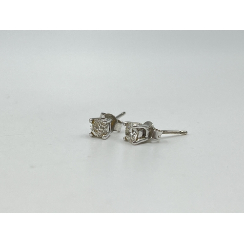 1233E - A pair of hallmarked 18ct white gold diamond stud earrings - approx. gross weight 1.12 grams