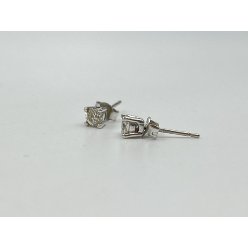 1233E - A pair of hallmarked 18ct white gold diamond stud earrings - approx. gross weight 1.12 grams