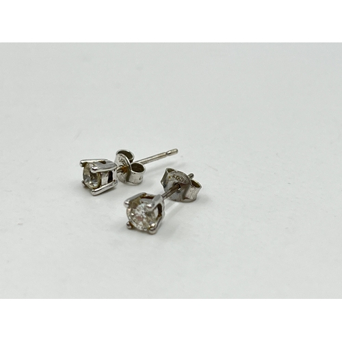 1233E - A pair of hallmarked 18ct white gold diamond stud earrings - approx. gross weight 1.12 grams