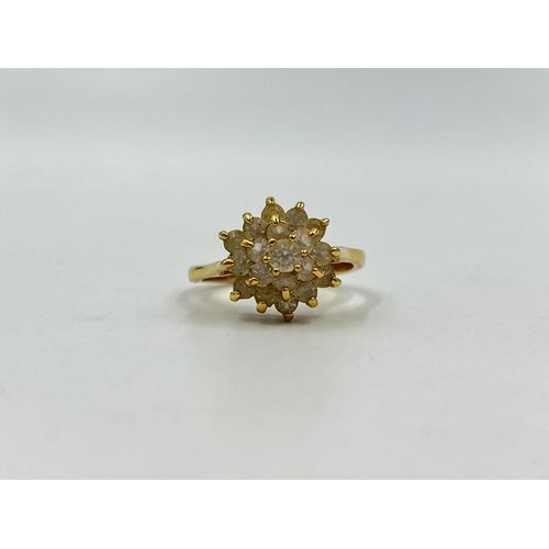 1254 - A yellow metal CZ cluster dress ring, stamped 18k to reverse, size R - approx. gross weight 3.67 gra... 