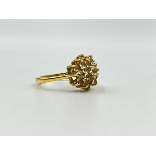 1254 - A yellow metal CZ cluster dress ring, stamped 18k to reverse, size R - approx. gross weight 3.67 gra... 