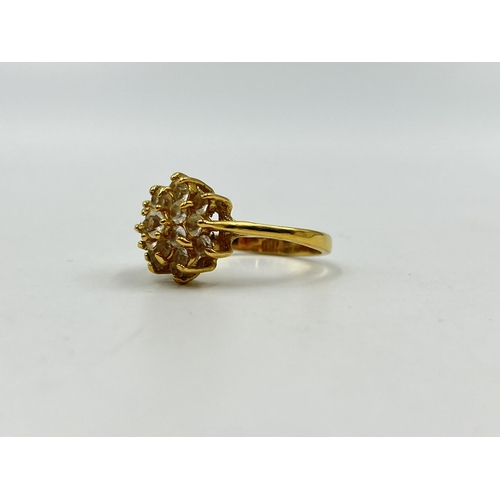 1254 - A yellow metal CZ cluster dress ring, stamped 18k to reverse, size R - approx. gross weight 3.67 gra... 