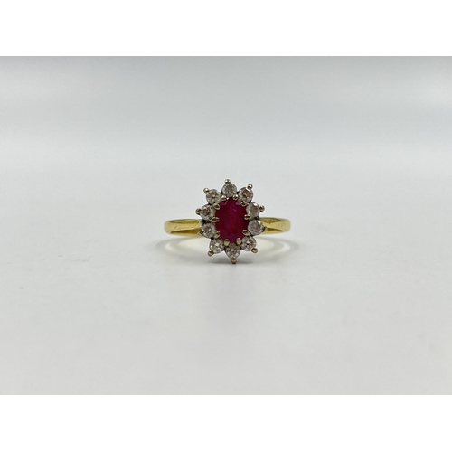 1258 - A hallmarked 18ct gold ruby and diamond halo ring, size U - approx. gross weight 3.82 grams